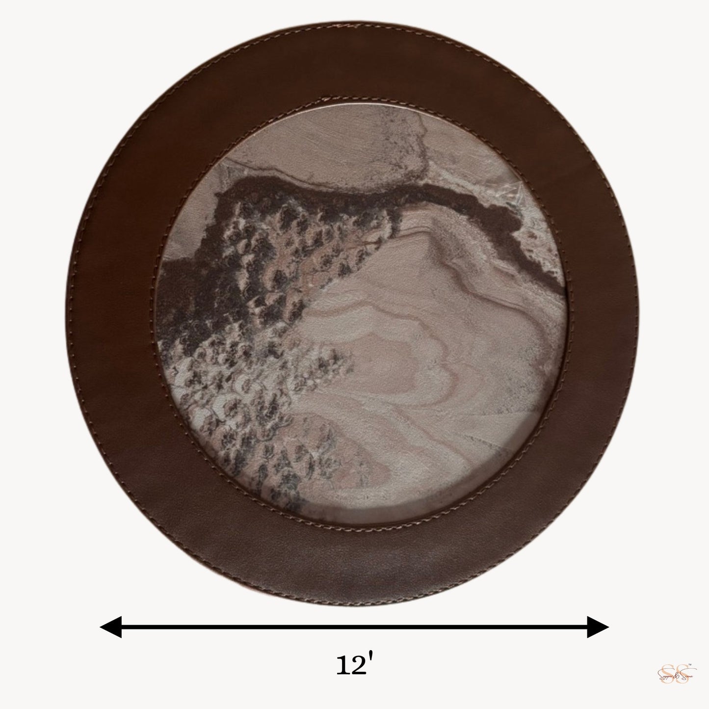 Round side table mat with a marble pattern with a brown leather border, having 12' diameter.