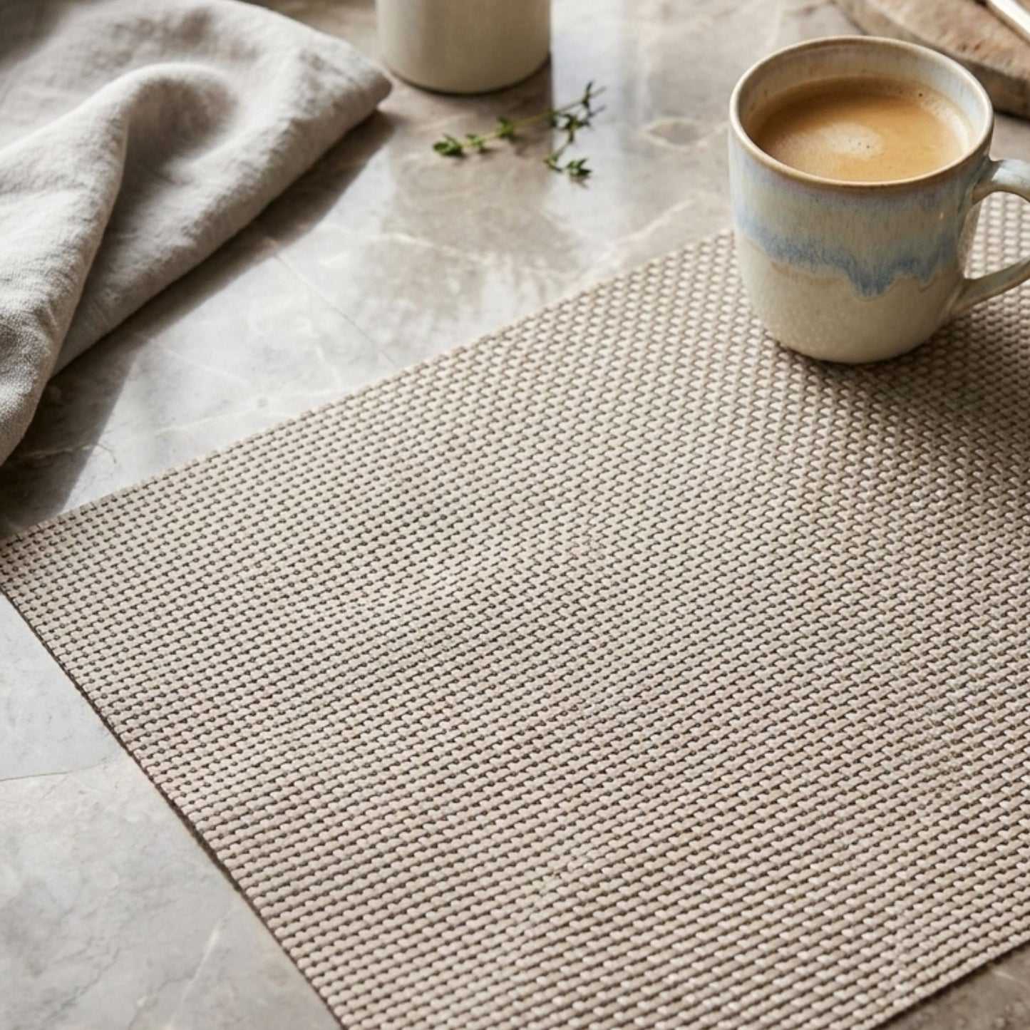 Light beige basket weave table mat rectangular placemat with coffee mug on marble table