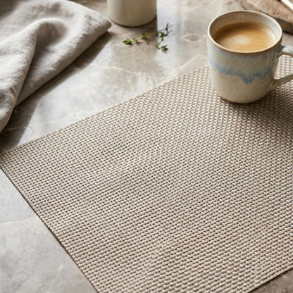 Light beige basket weave table mat rectangular placemat with coffee mug on marble table