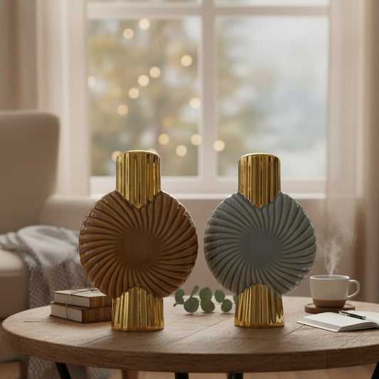 Two decorative vases on a wooden table with a blurred background