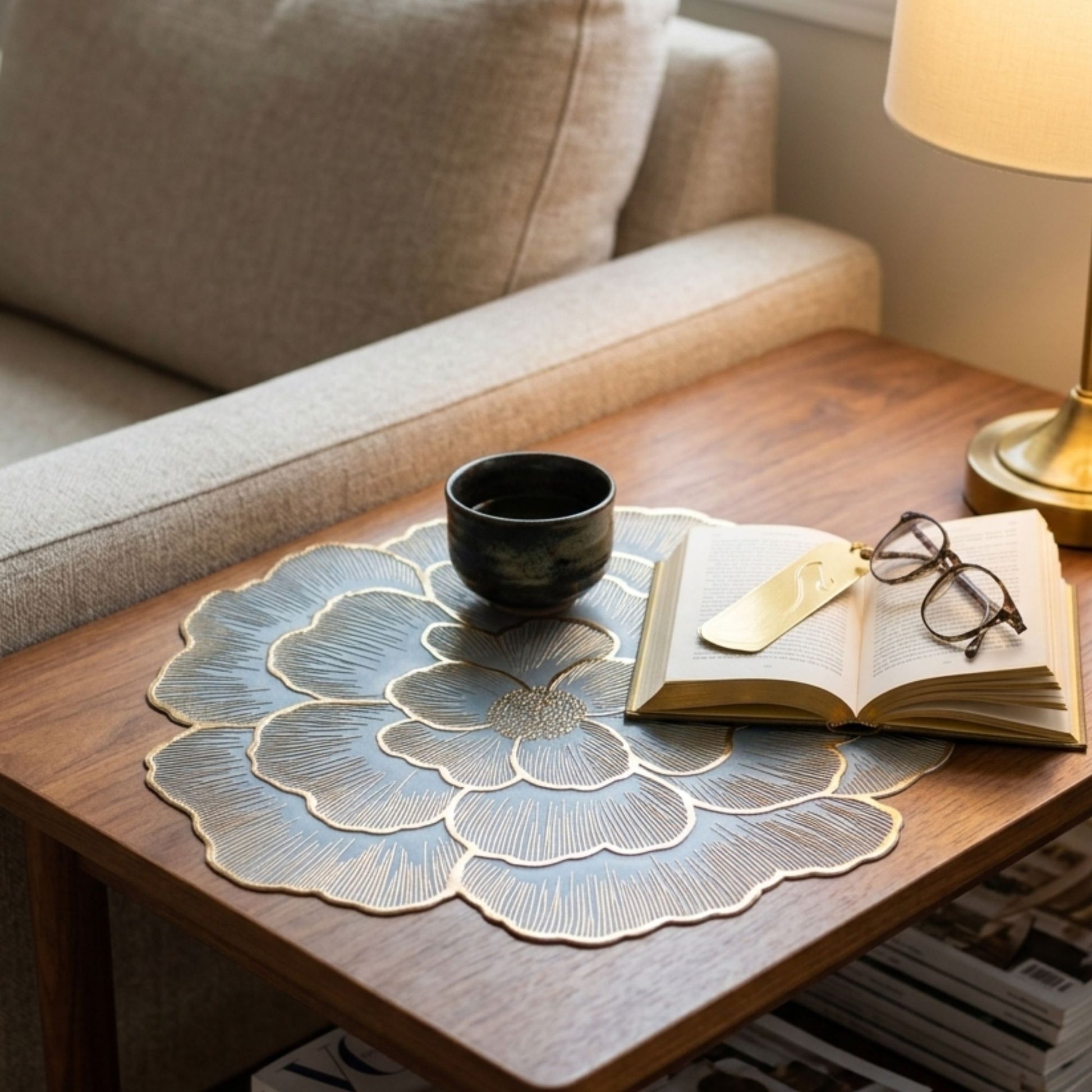 Blue and gold chrome flower-shaped side mat for coffee table styling by Supper & Scene.