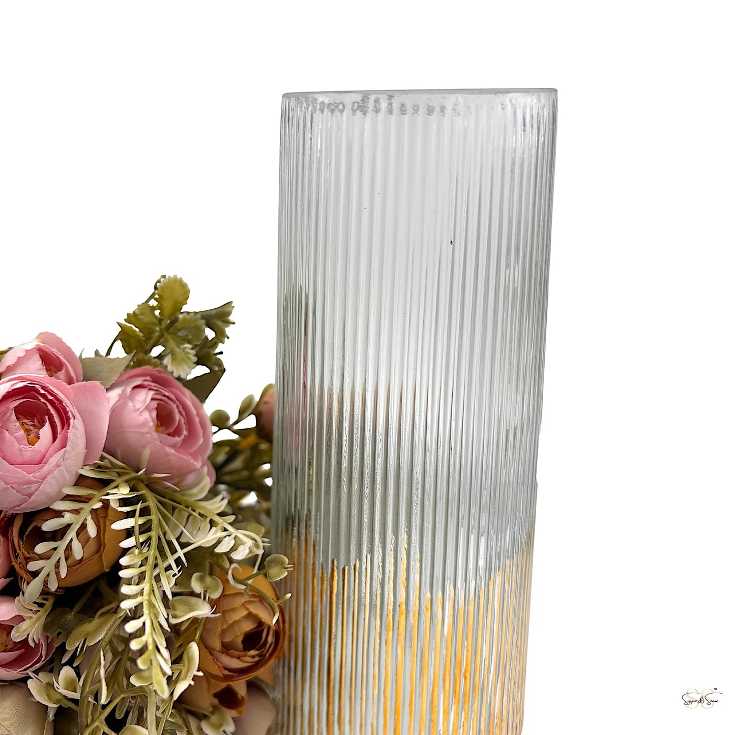 Clear ribbed glass vase with gold accent base styled with pink artificial florals — modern decorative piece by Supper & Scene.