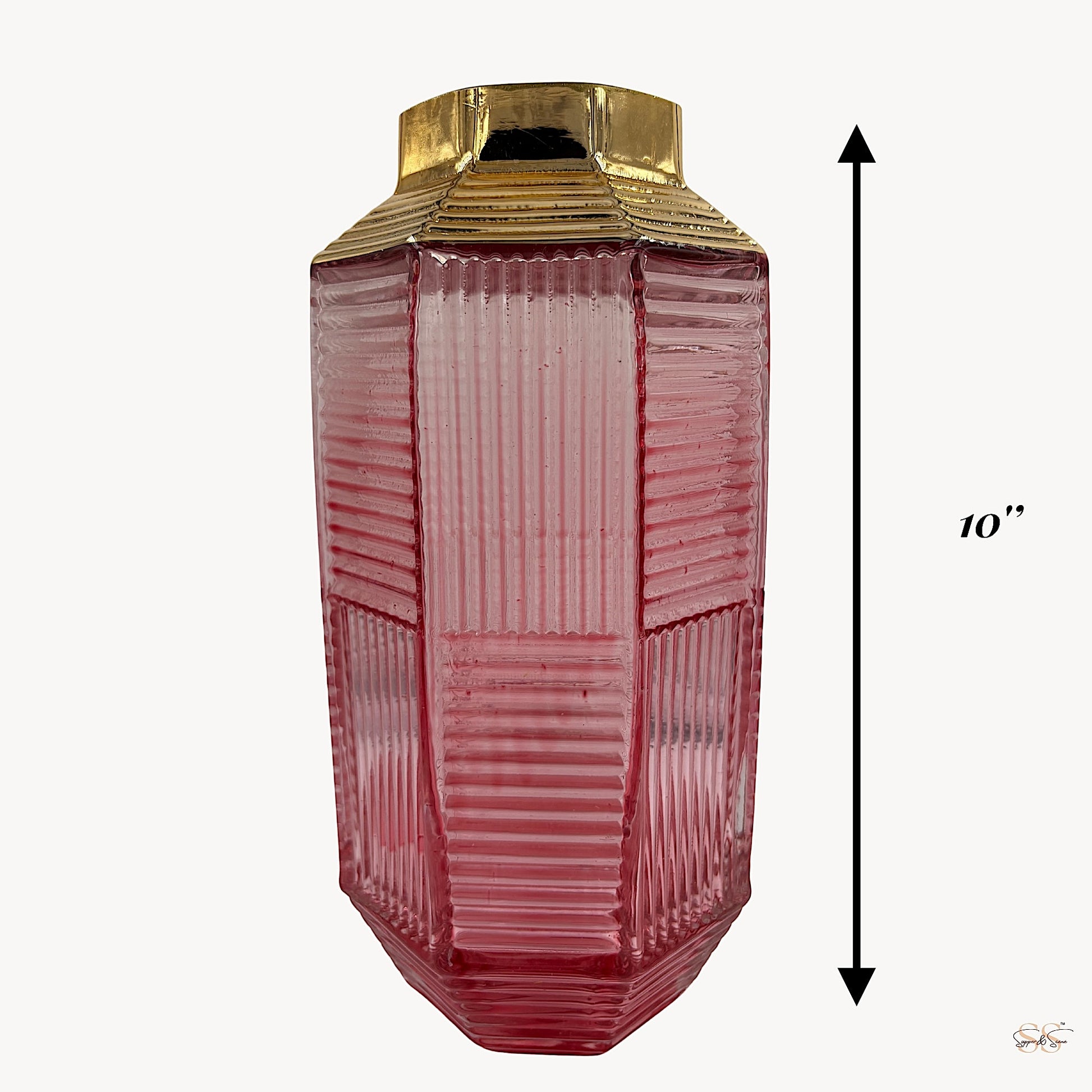 Tall pink ribbed glass vase with a gold-plated top, measuring 10 inches in height, displayed against a plain background by Supper & Scene.