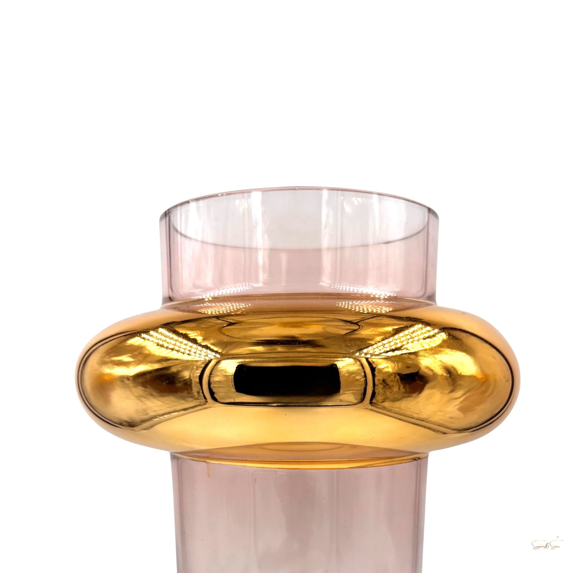 Close-up shot of a tall pink glass vase with a bold gold circular band around the center, highlighting its glossy modern finish by Supper & Scene.