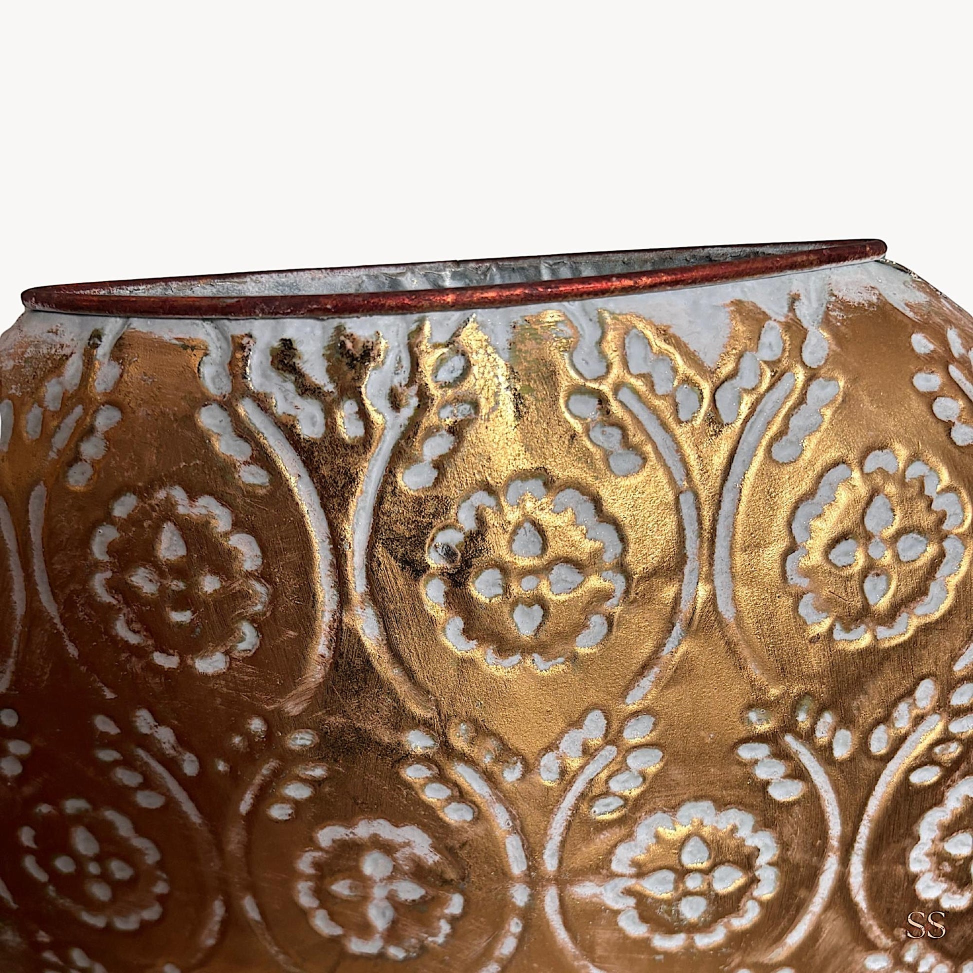 Vintage-inspired gold and white embossed metal showpiece styled in a modern home setting, adding an elegant decorative touch by Supper & Scene.