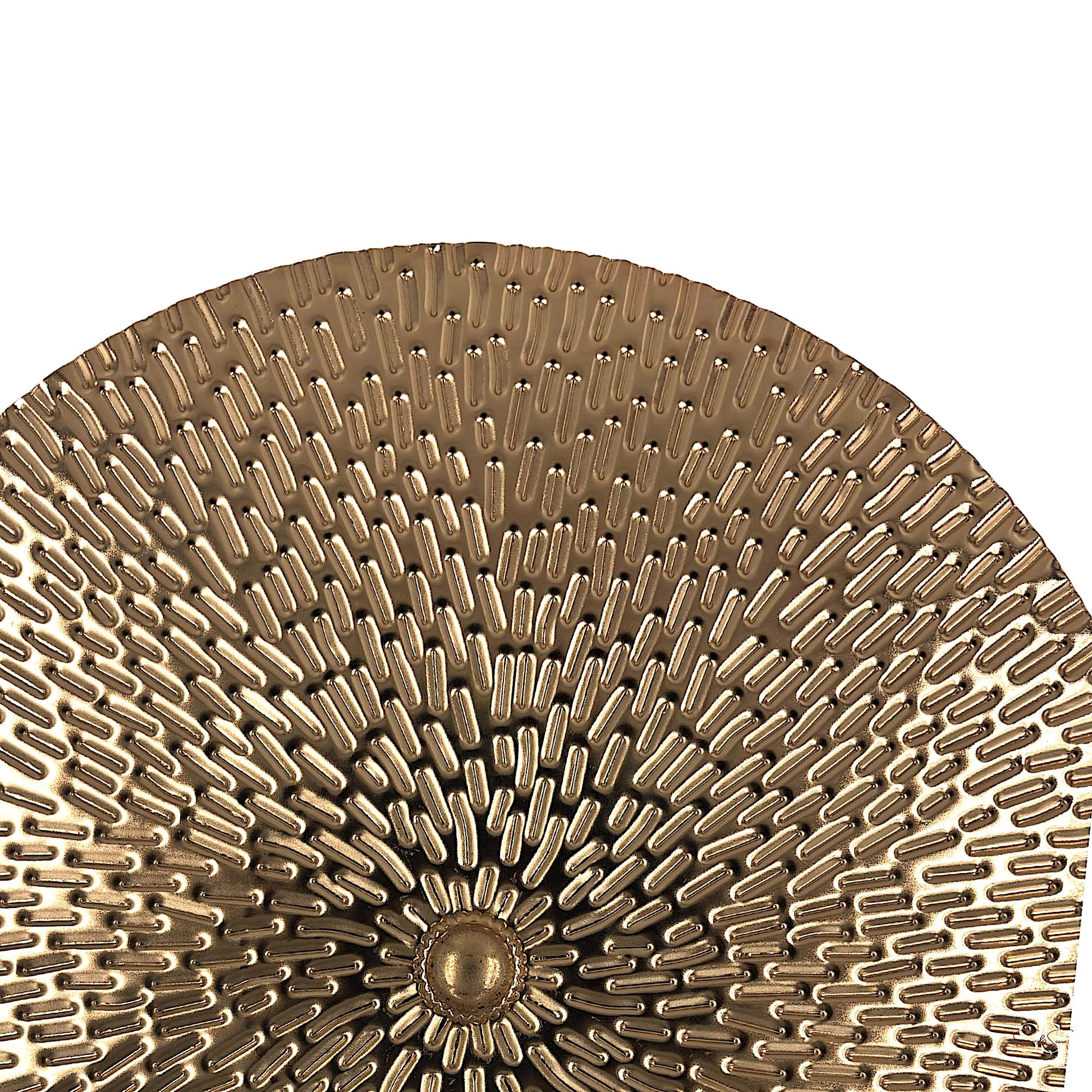 Close-up image of a round gold metal decorative platter with dense textured detailing and a central raised dot, by Supper & Scene.