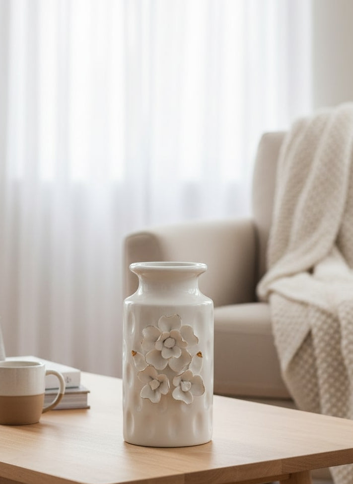 White ceramic vase with floral design on a wooden coffee table in a living room setting by supper and scene