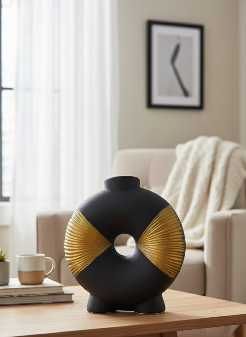 decorative black and gold vase on a wooden table in a living room setting by supper and scene.