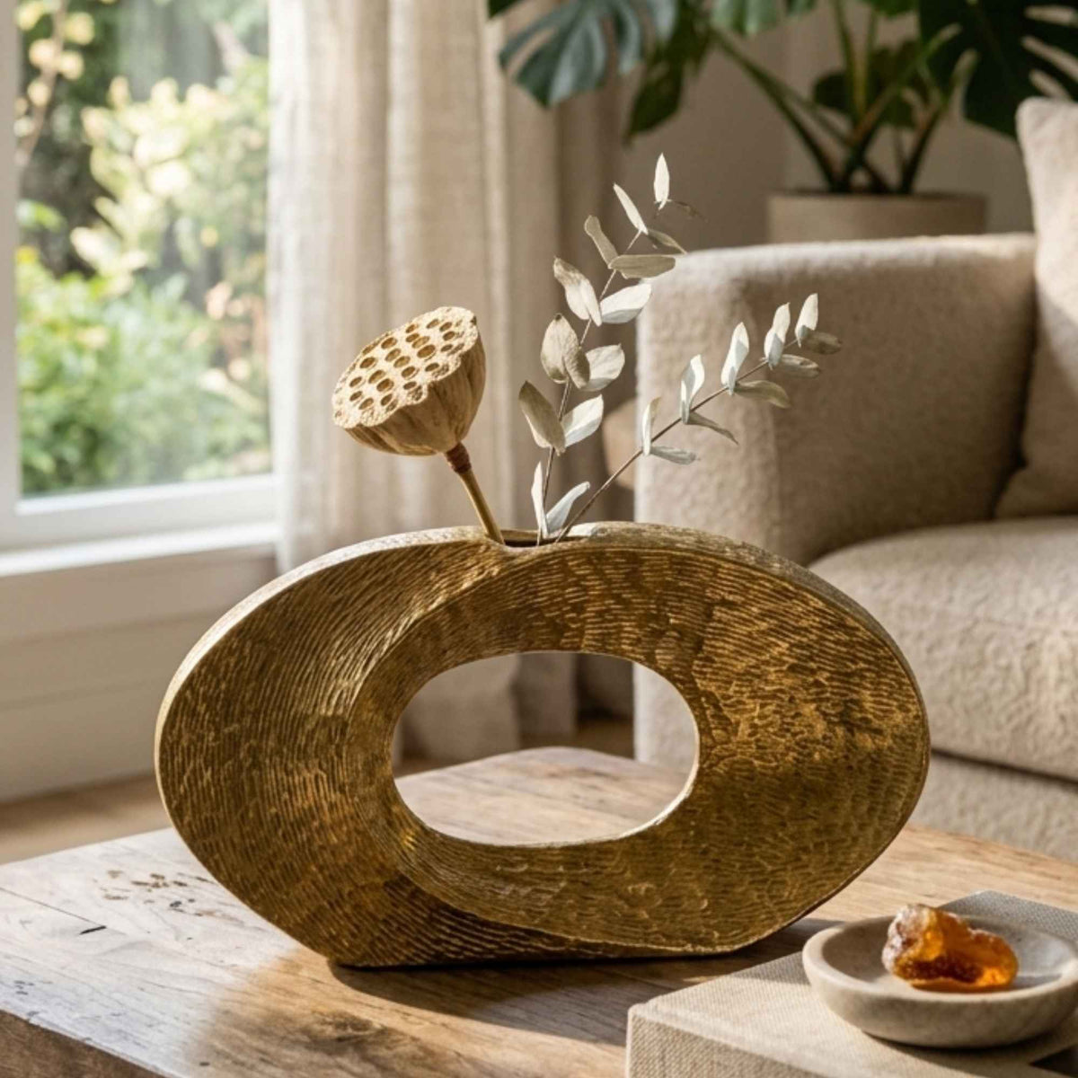 Golden metallic sculptural showpiece vase styled as a home decor accent by Supper & Scene.