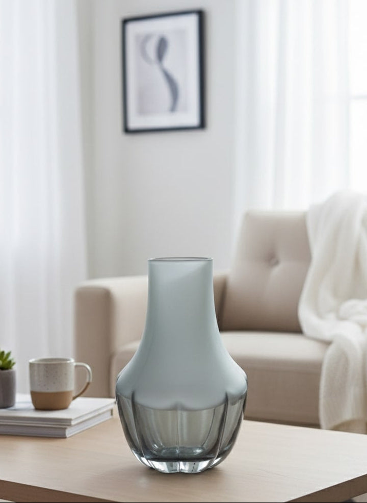 Glass vase on a coffee table in a living room setting by supper and scene 