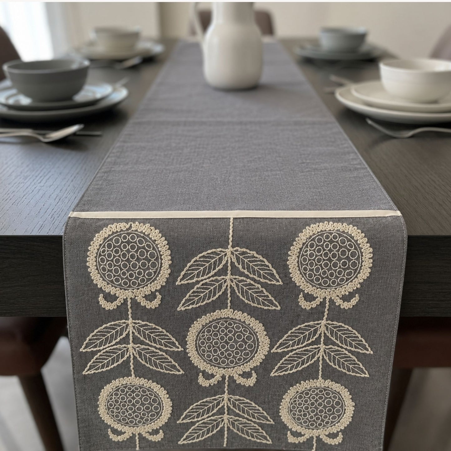 Grey floral embroidered fabric table runner for elegant dining table styling by Supper & Scene.
