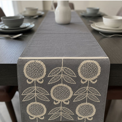 Grey floral embroidered fabric table runner for elegant dining table styling by Supper & Scene.