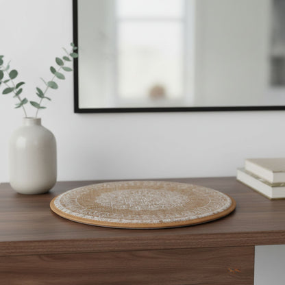 Round white woven placemat on a wooden surface with a vase and books in the background.