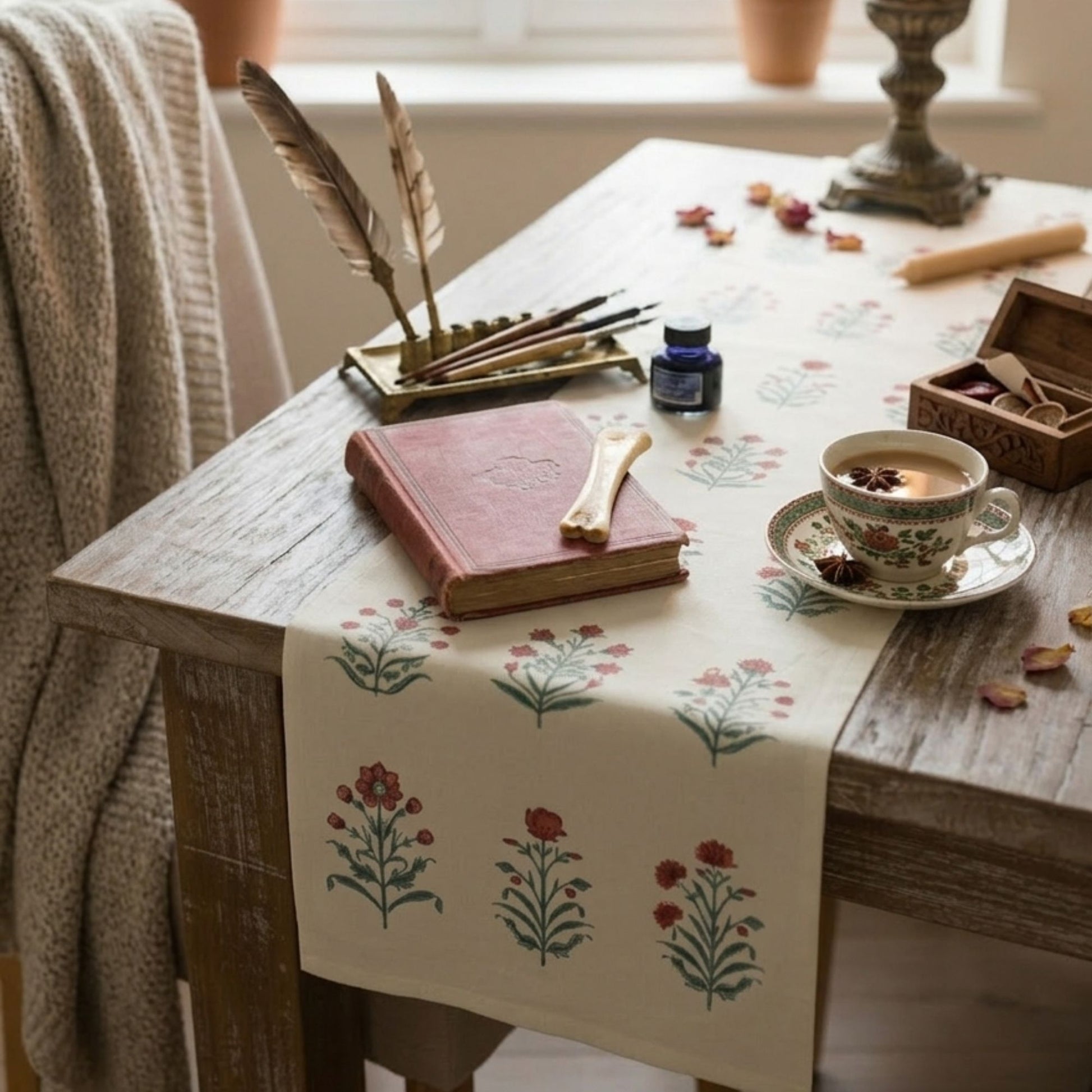 Cream velvet table runner with red floral print styled on wooden dining table decorative botanical table runner