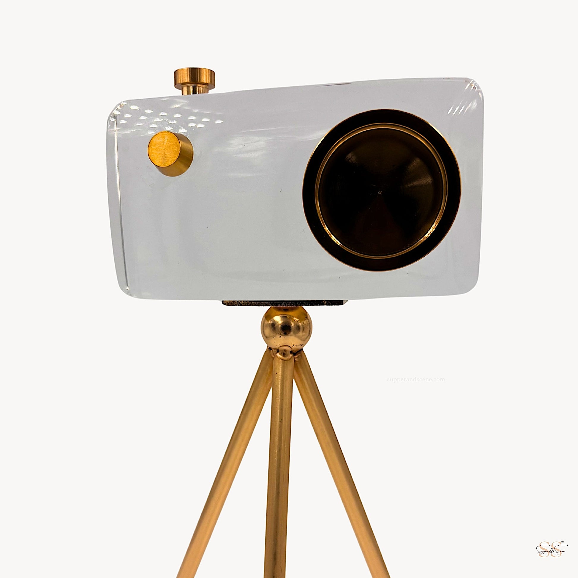 Modern crystal camera showpiece with gold detailing on a sleek tripod stand by Supper & Scene