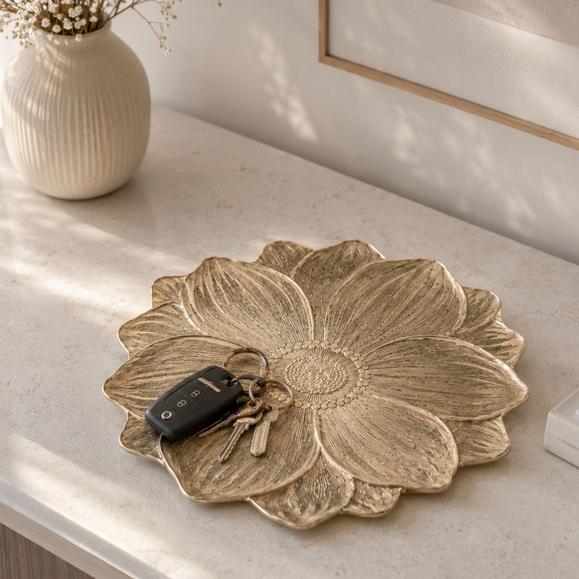 Metallic gold flower-shaped side mat for console table decor by Supper & Scene.