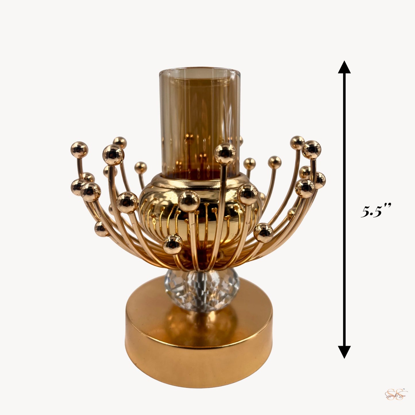 Gold candle holder with crystal base and glass candle on a white background