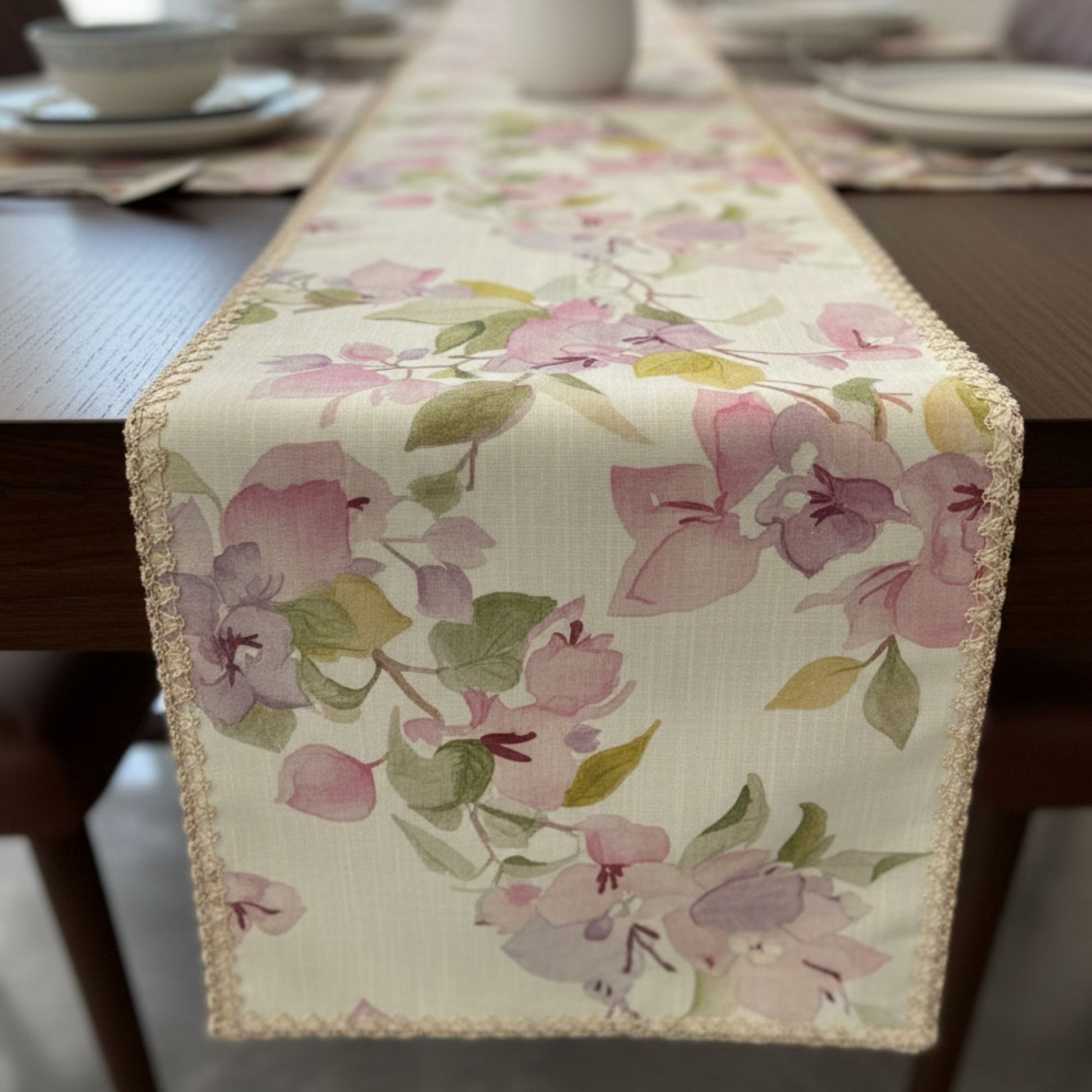 Floral printed dining table runner with soft pink botanical pattern and vase styling