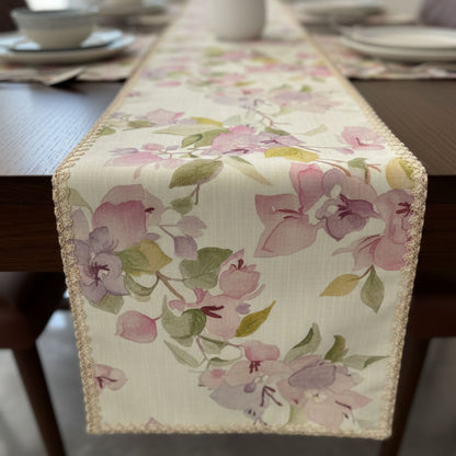Floral printed dining table runner with soft pink botanical pattern and vase styling
