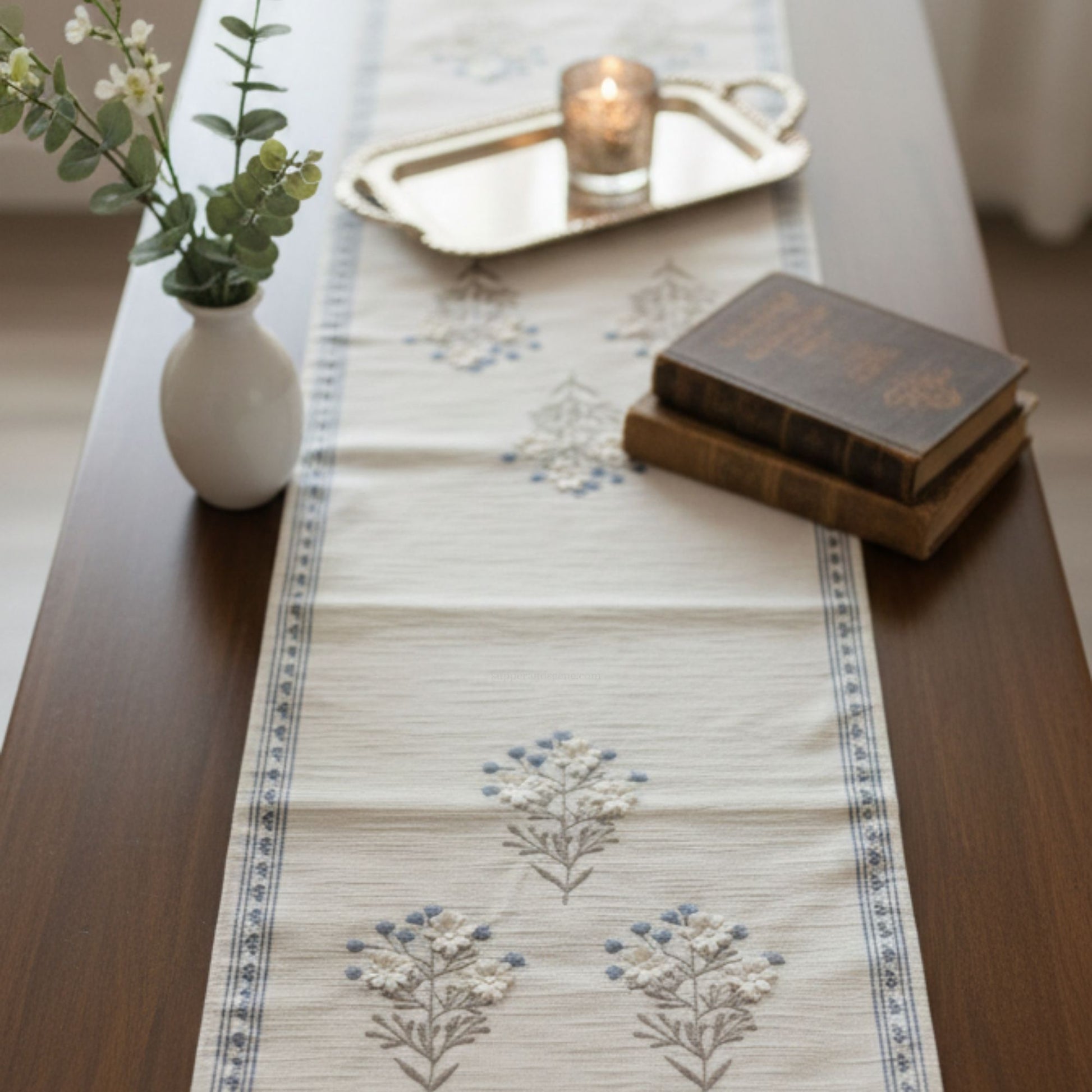 short blue embroidery table runner on console