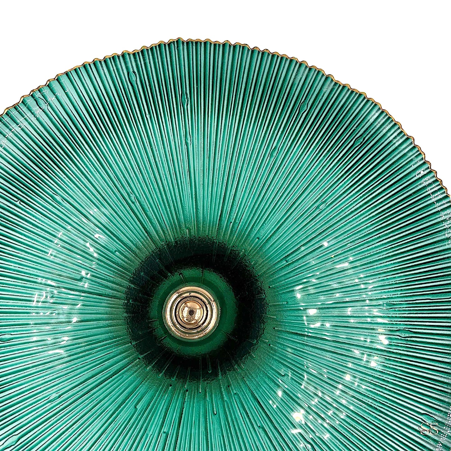 Close-up of a textured green glass platter with gold-edged detailing by Supper & Scene.