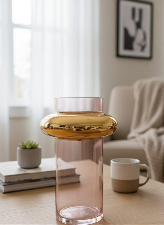 Glass vase with gold accent on a wooden table in a living room setting by supper and scene