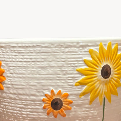 Close up of sunflower design on textured ceramic planter decorative indoor flower pot for succulents