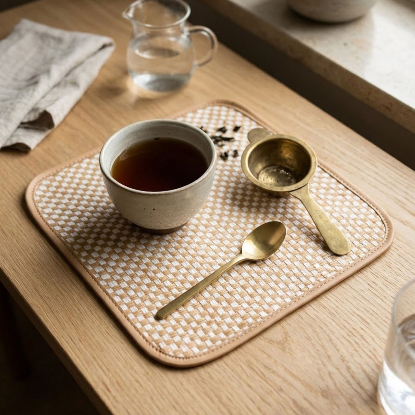 Square bamboo side mat set of 2 natural woven placemat styled with tea cup and brass spoon