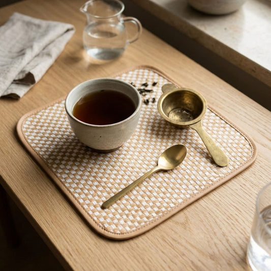 Square bamboo side mat set of 2 natural woven placemat styled with tea cup and brass spoon
