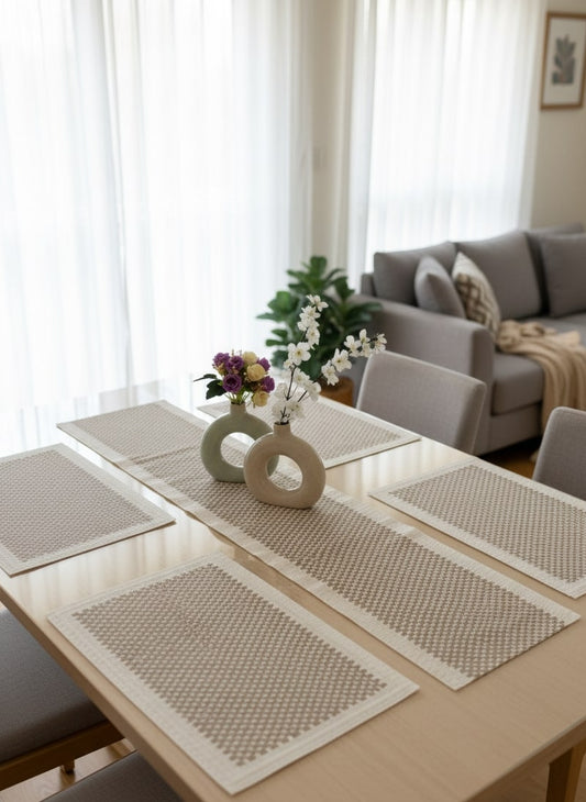 Dining table set for 6 with placemats and vases in a living room by supper and scene