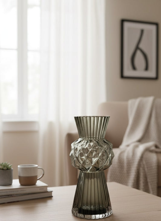 Decorative black glass vase on a coffee table with a blurred living room background by supper and scene